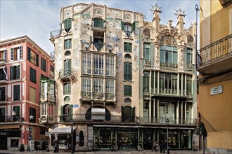 Colorful Art Nouveau buildings with ornate facades lining a European city street, Palma De Mallorca