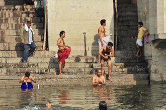 Local people traditionally bathe at the ghats of a river in India, Varanasi, Uttar Pradesh, India,
