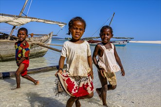 Kids playing on a little sailing boat, Nosy Iranja near Nosy Be, Madagascar, Africa
