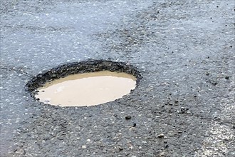 Large pothole in an asphalt road, Alaska Highway, Yukon Territory, Canada, North America