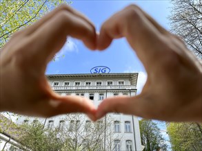 Hands Making a Heart Shape on SIG (Swiss Industrial Company) Industry Building in Neuhausen in