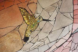 Wall mosaic with hummingbird in flight by Isidora Paz Lopez 2019, one, yellow, golden, flight, bird