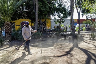 Oaxaca, Mexico, A worker cleans El Llano Park, Central America
