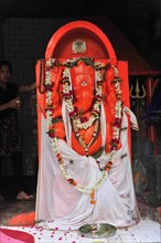 A statue of the Hindu deity Ganesh, surrounded by garlands of flowers, Varanasi, Uttar Pradesh,