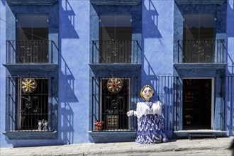 Oaxaca, Mexico, A giant papier mache puppet (mono de calenda) in front of a store on Calle