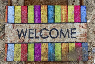 Doormat with the word welcome, greeting, friendly, inviting, colourful, colourful, decoration,