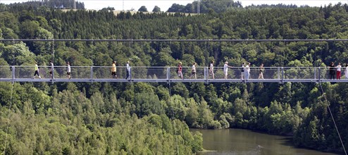 Visitors cross the rope suspension bridge at the Rappbode dam, 483 metres long, 100 metres above