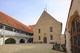 Hospital with arcade and hospital church, historic half-timbered house, inner courtyard,