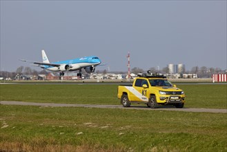 Bird Control Vehicle K1 patrols and KLM Cityhopper Embraer E195-E2 with registration PH-NXI lands