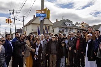 Hamtramck, Michigan USA, 7 March 2024, Community members gather around the street sign after a