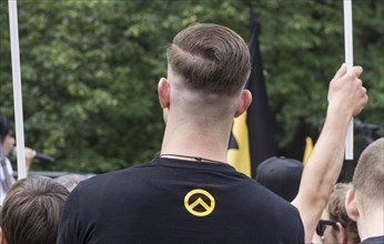 A member of the Identitarian Movement stands among the demonstrators with the Identitarian Movement