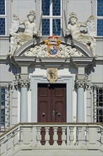 Portal with town coat of arms, figures, parapet and decorations of the baroque town hall, detail,