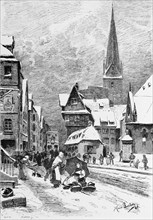 Winter street scene, stone street in the city centre, snow, street, church, building, sale,