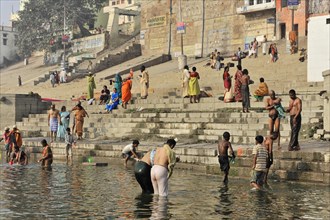 People bathing and playing in the river on a sunny day, Varanasi, Uttar Pradesh, India, Asia