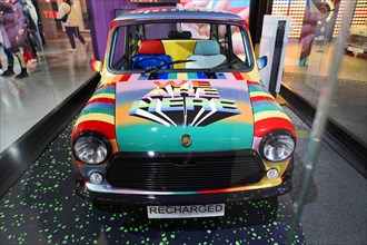 A colourfully designed Mini Cooper stands as an exhibit in a room, BMW WELT, Munich, Germany,