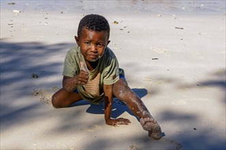 Little boy playing on a beach on the island Nosy Iranja near Nosy Be, Madagascar, Africa