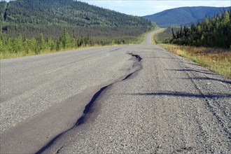 Road with large bumps and potholes, wilderness and vastness, Alaska Highway, Yukon Territory,