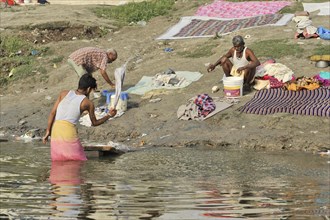 People washing clothes in the river, traditional outdoor scene, Varanasi, Uttar Pradesh, India,