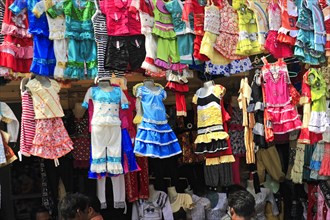 Market stall with a selection of colourful children's clothes, different designs, Varanasi, Uttar
