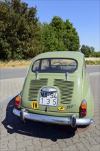 Rear view of a green vintage car on a sunny day on a road, Seat 600 E, Peine, Lower Saxony,