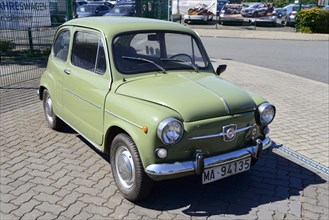 Front view of a green vintage Fiat parked on a cobbled street, Seat 600 E, Peine, Lower Saxony,