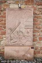 Memorial stone with relief for the construction of the church, sandstone, red, construction worker,