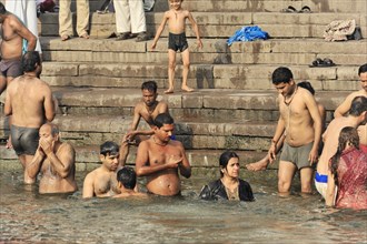 People taking a communal bath in the river, indicating social bonding, Varanasi, Uttar Pradesh,