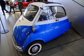 A classic blue and white small car presented in an exhibition hall, BMW WELT, Munich, Germany,