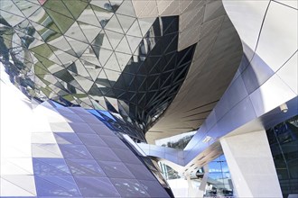 View of a complex glass shell of a building with fascinating reflections and shapes, BMW WELT,