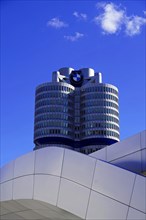 Partial view of the BMW headquarters with company logo against a clear sky, BMW WELT, Munich,