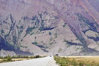 Highway leads towards barren mountains, wilderness, Kluane Lake, Alaska Highway, Yukon Territory,