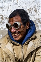 Man with historic sun glasses, Lo Manthang, Kingdom of Mustang, Nepal, Asia