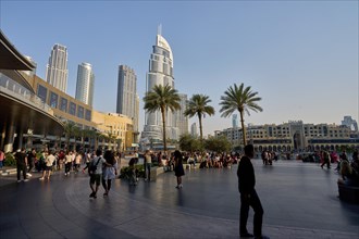 Tourists in front of the skyscraper backdrop at Lake Burj Khalifa. Dubai, United Arab Emirates,