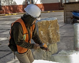Oaxaca, Mexico, A worker chisels a block of stone to use in repairs on Guadalupe Church, Central