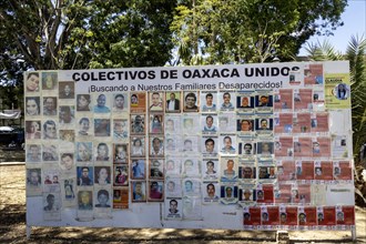 Oaxaca, Mexico, A billboard in the zocalo shows the faces of persons who have disappeared. Over the