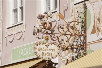 Old, decorated hanging sign of the Kraetz bakery in Ludwigstrasse, Partenkirchen district,