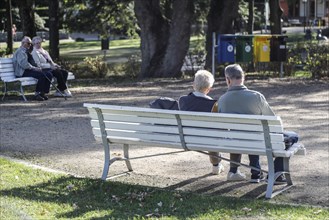 Retired couples sitting on benches in a park, Bad Harzburg, 06.10.2018