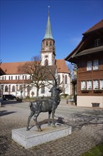 Stag sculpture and St Blasius church in Glottertal, Breisgau-Hochschwarzwald district,