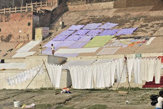 White sheets drying on a washing line near a river bank, Varanasi, Uttar Pradesh, India, Asia