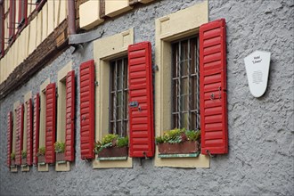Row of red shutters on the Hotel Loewen, bars, bars, metal bars, shutter, house wall, red, window,