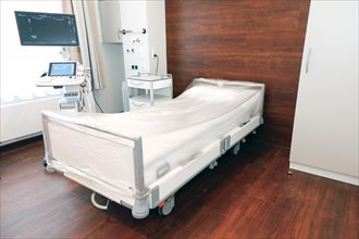 An ultrasound machine stands next to the patient's bed in a hospital room in Berlin, 25 January