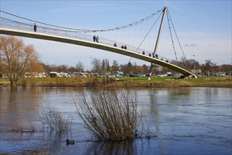 The curved suspension bridge designed by Joerg Schlaich, called Glacisbruecke, crosses the Weser