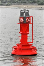 A red buoy on the water with solar panels and the number 136, Hamburg, Hanseatic City of Hamburg,
