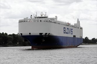 A large cargo ship named GLOVIS on a river under a cloudy sky, Hamburg, Hanseatic City of Hamburg,