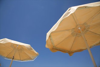 Sunshades against deep blue Mediterranean sky