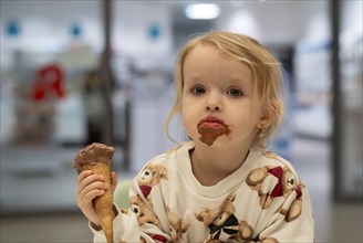 Interior shot, girl, 2-3 years, blonde, eating chocolate ice cream, ice cream, waffle, mouth