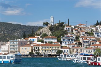 View of an idyllic Mediterranean coastal town with harbour, whitewashed houses and blue sky, view