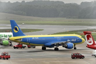 Blue and yellow Ukraine International aircraft on the tarmac, Hamburg, Hanseatic City of Hamburg,