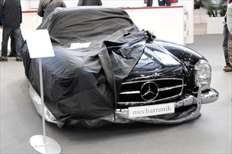 RETRO CLASSICS 2010, Stuttgart Messe, A Mercedes-Benz partially covered with a tarpaulin in a