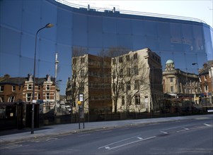 Buildings reflected in glass of award winning Willis Corroon building, architect Norman Foster,